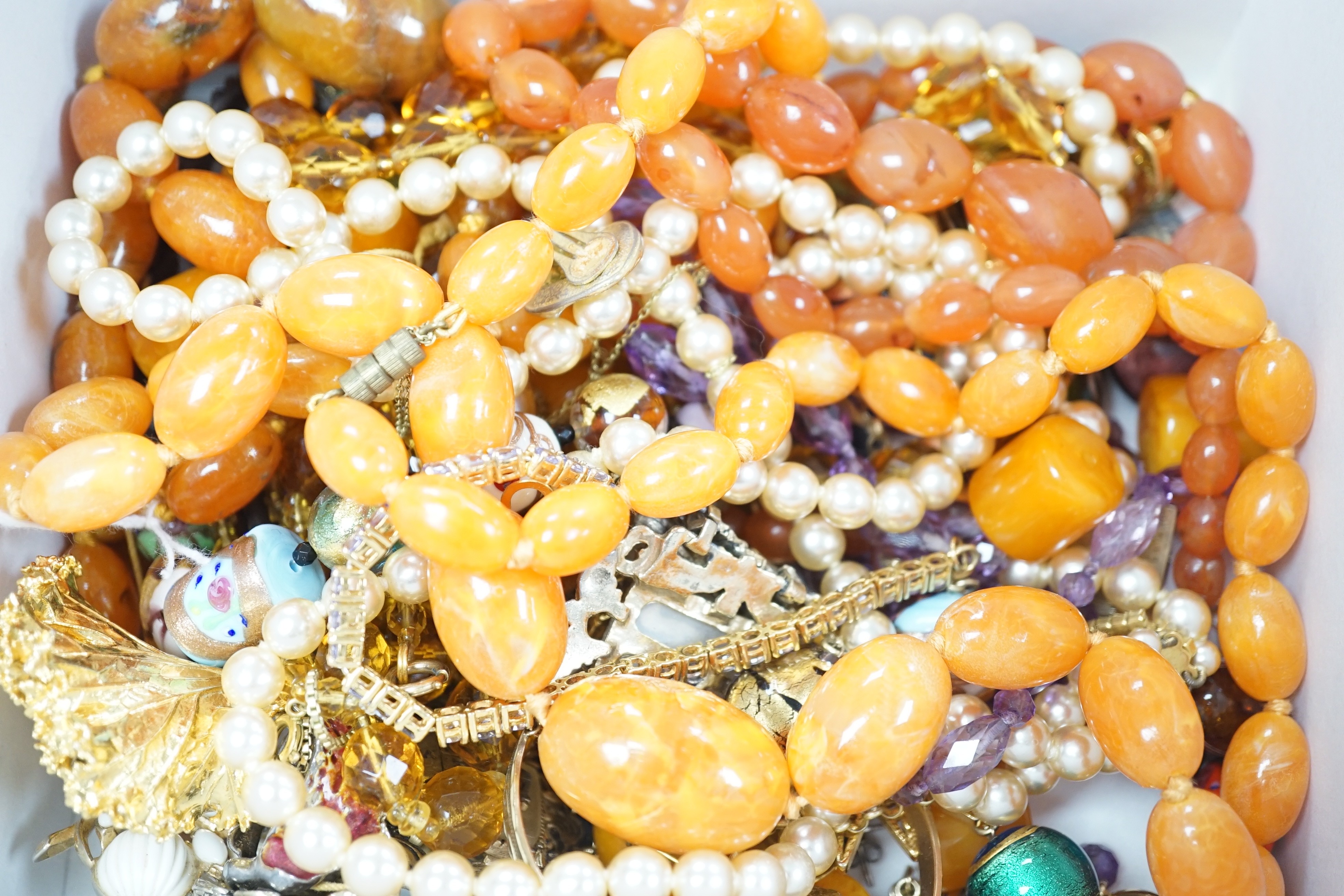 Mixed costume jewellery, including simulated amber necklaces.